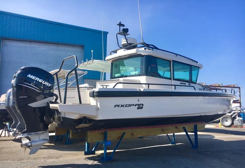 Slide: The Image of 2019 Axopar 28 CABIN boat with Mercury engine on display. - 2
