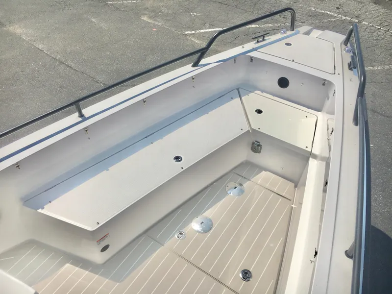 Slide: The Image of 2019 Axopar 28 CABIN boat interior with seating and storage compartments. - 20