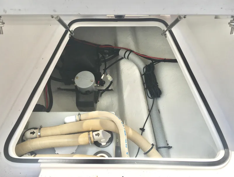 Slide: The Image of Engine compartment of 2019 Axopar 28 CABIN with visible hoses and wiring. - 22