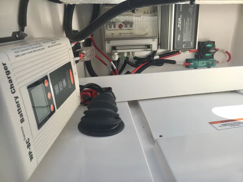 Slide: The Image of Battery charger and electrical components inside 2019 Axopar 28 CABIN boat. - 23