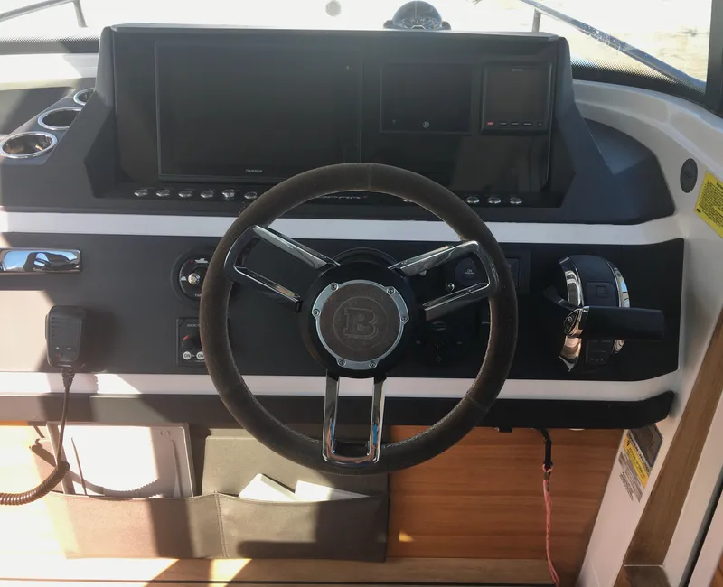 Slide: The Image of Steering wheel and dashboard of 2019 Axopar 28 CABIN boat. - 26