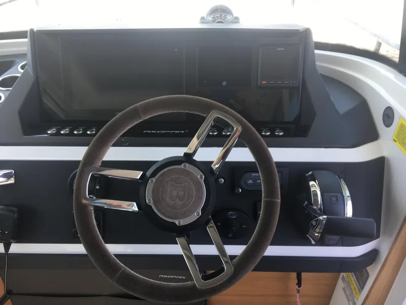 Slide: The Image of Steering wheel and dashboard of 2019 Axopar 28 CABIN boat. - 27