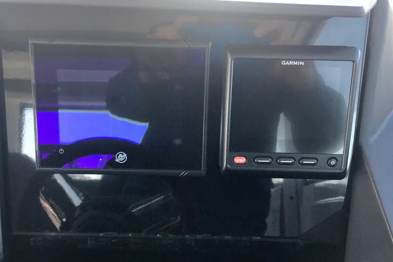Slide: The Image of Dashboard of 2019 Axopar 28 CABIN with Garmin display and controls. - 28