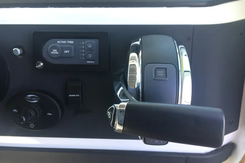 Slide: The Image of Control panel of 2019 Axopar 28 CABIN boat with throttle and trim settings. - 29