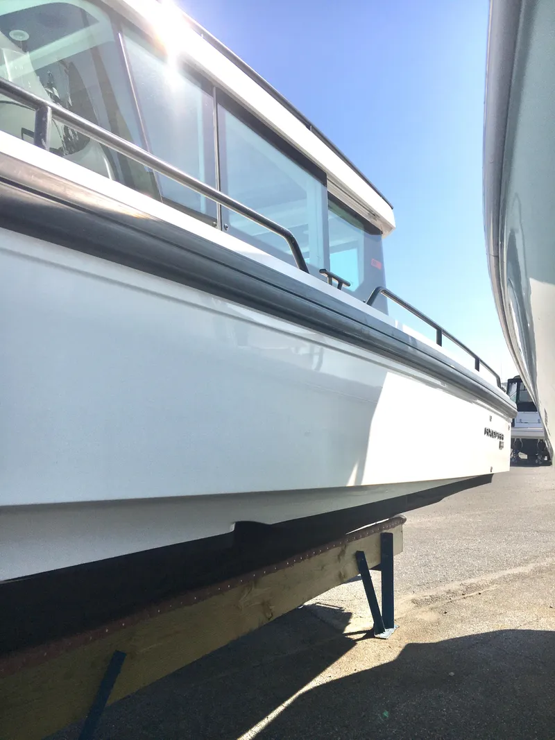 Slide: The Image of 2019 Axopar 28 CABIN boat on display under clear blue sky. - 3