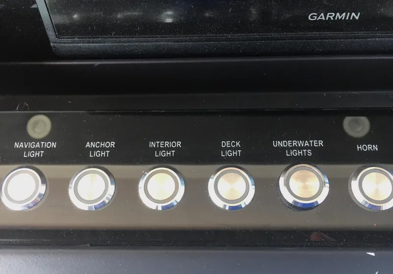 Slide: The Image of Control panel of 2019 Axopar 28 CABIN with light and horn switches. - 30