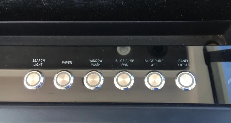 Slide: The Image of Control panel of a 2019 Axopar 28 CABIN boat with labeled buttons. - 31