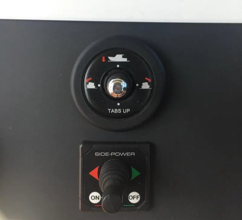 Slide: The Image of Control panel of a 2019 Axopar 28 CABIN boat with trim tabs and side-power switch. - 33