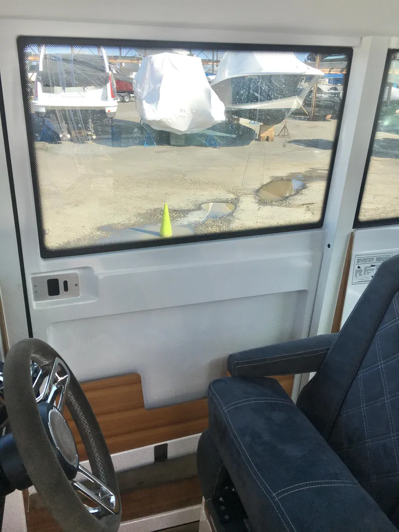 Slide: The Image of Interior view of 2019 Axopar 28 CABIN boat with steering wheel and seat. - 35