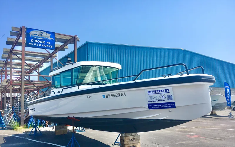 Slide: The Image of 2019 Axopar 28 CABIN boat displayed at East Shore Marine dock. - 4