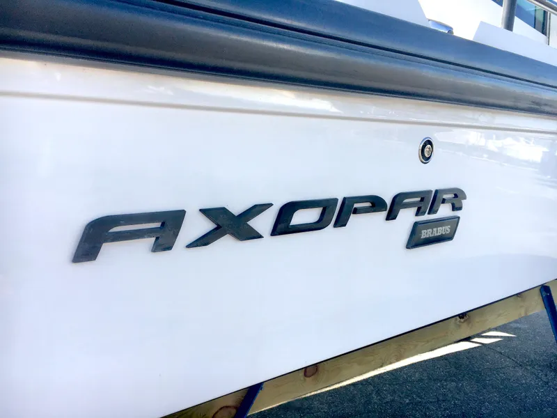 Slide: The Image of Close-up of 2019 Axopar 28 CABIN boat logo on white hull. - 42