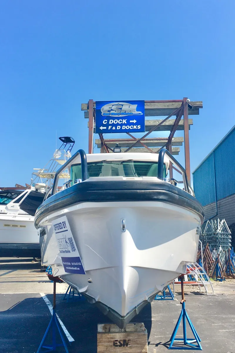 Slide: The Image of 2019 Axopar 28 CABIN boat on display at a dockyard. - 6