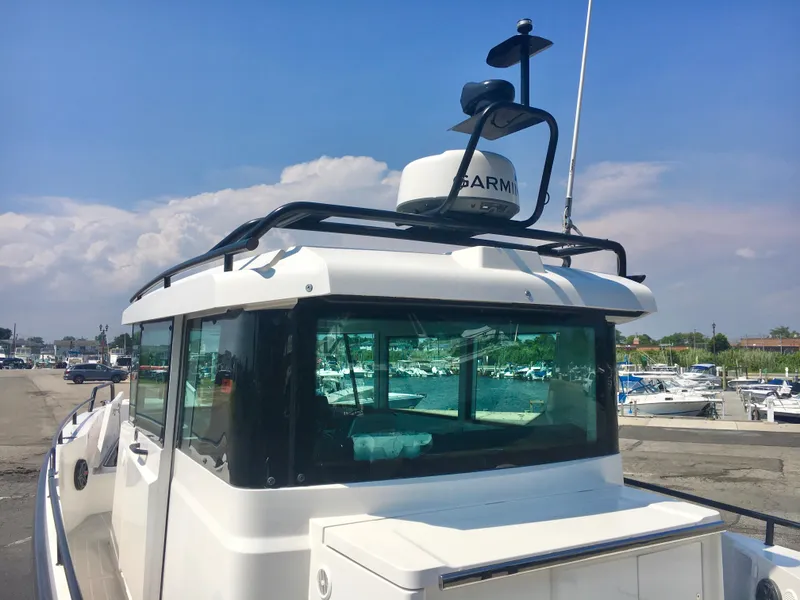 Slide: The Image of 2019 Axopar 28 CABIN boat docked at marina under clear blue sky. - 8