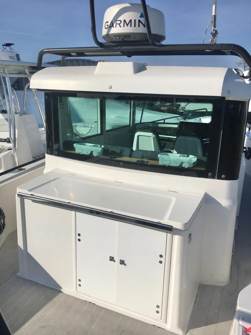 Slide: The Image of 2019 Axopar 28 CABIN boat with Garmin equipment, rear view. - 9
