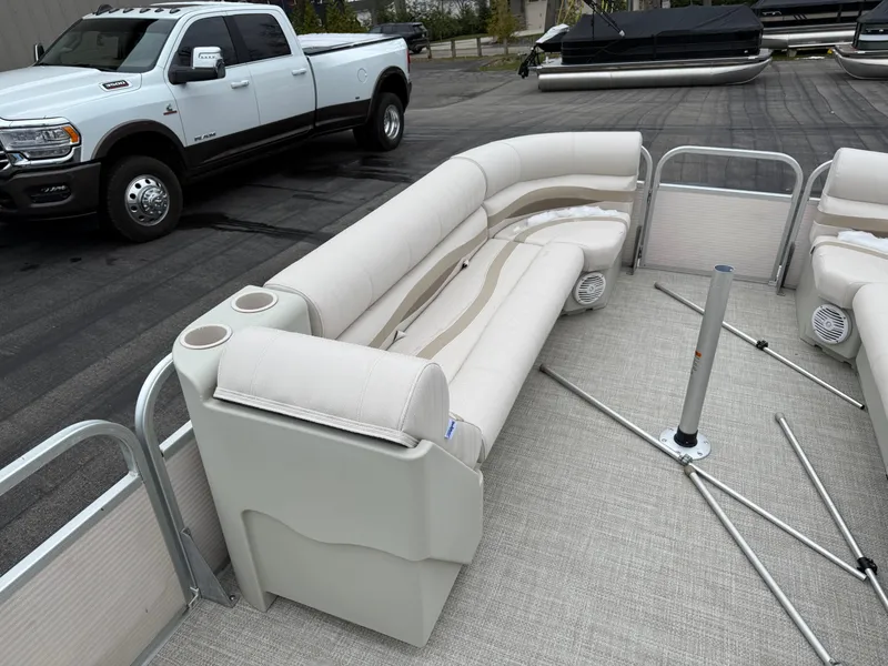 Slide: The Image of 1996 Premier Grand Majestic pontoon boat interior with beige seating and cup holders. - 11