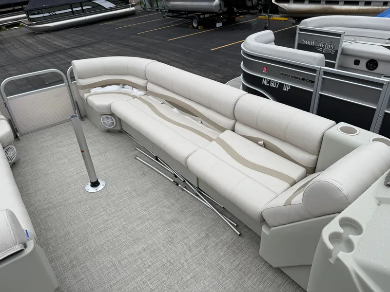 Slide: The Image of Luxurious seating on a 1996 Premier Grand Majestic pontoon boat, featuring beige upholstery. - 12