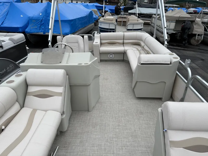 Slide: The Image of Spacious 1996 Premier Grand Majestic pontoon boat with beige seating and steering console. - 13