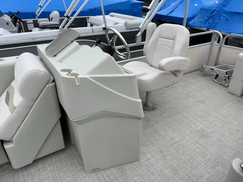 Slide: The Image of Interior of a 1996 Premier Grand Majestic boat with white seating and steering console. - 15