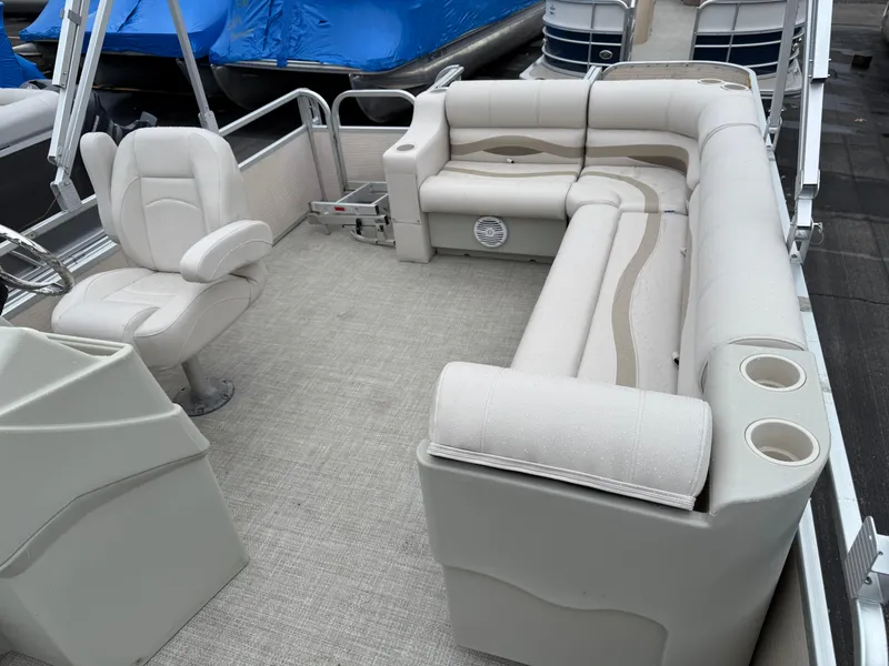 Slide: The Image of 1996 Premier Grand Majestic boat interior with beige seating and steering console. - 16