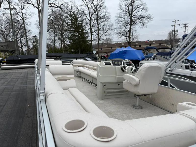 Slide: The Image of 1996 Premier Grand Majestic boat with spacious seating and steering console, docked outdoors. - 19