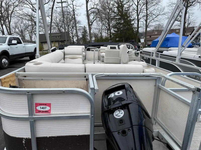 Slide: The Image of 1996 Premier Grand Majestic pontoon boat with outboard motor, parked in a lot. - 6