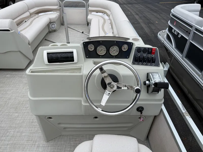 Slide: The Image of 1996 Premier Grand Majestic boat dashboard with steering wheel and control panel. - 9