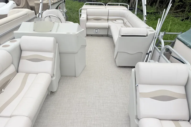 The Image of Luxurious 1996 Premier Grand Majestic pontoon boat interior with plush seating and helm. - 0