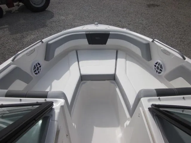 Slide: The Image of 2025 Chaparral 21 SSi boat interior with cushioned seating and speakers. - 10