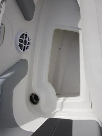 Slide: The Image of 2025 Chaparral 21 SSi boat interior storage compartment with speaker detail. - 12
