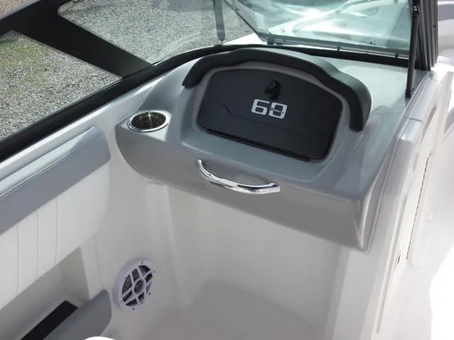 Slide: The Image of 2025 Chaparral 21 SSi boat interior with storage compartment and speaker. - 16