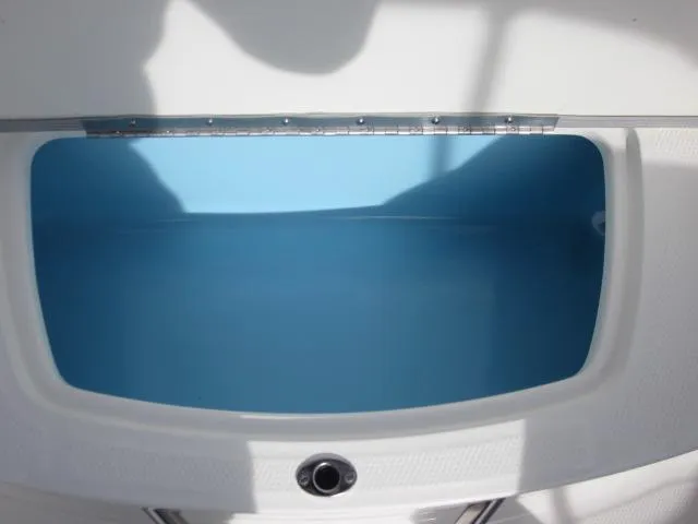 Slide: The Image of 2025 Chaparral 21 SSi boat storage compartment, open and empty, with blue interior. - 17