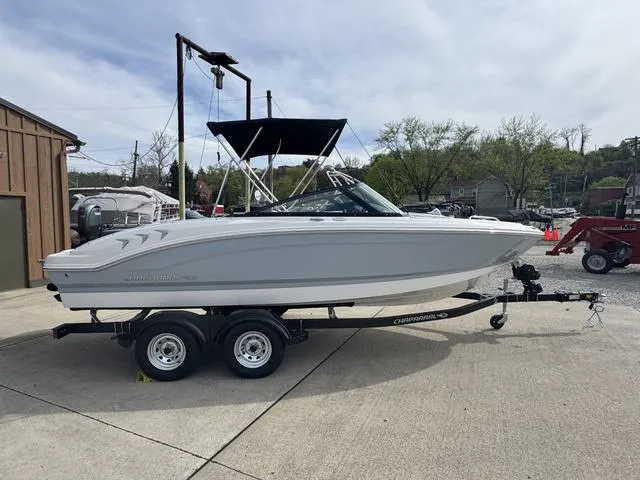 Slide: The Image of 2025 Chaparral 21 SSi boat on trailer, parked outdoors, side view. - 6