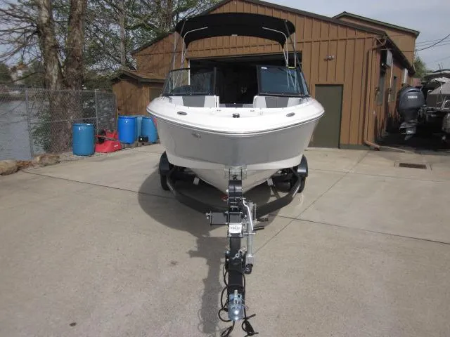 Slide: The Image of 2025 Chaparral 21 SSi boat on trailer, parked outdoors near a building. - 8