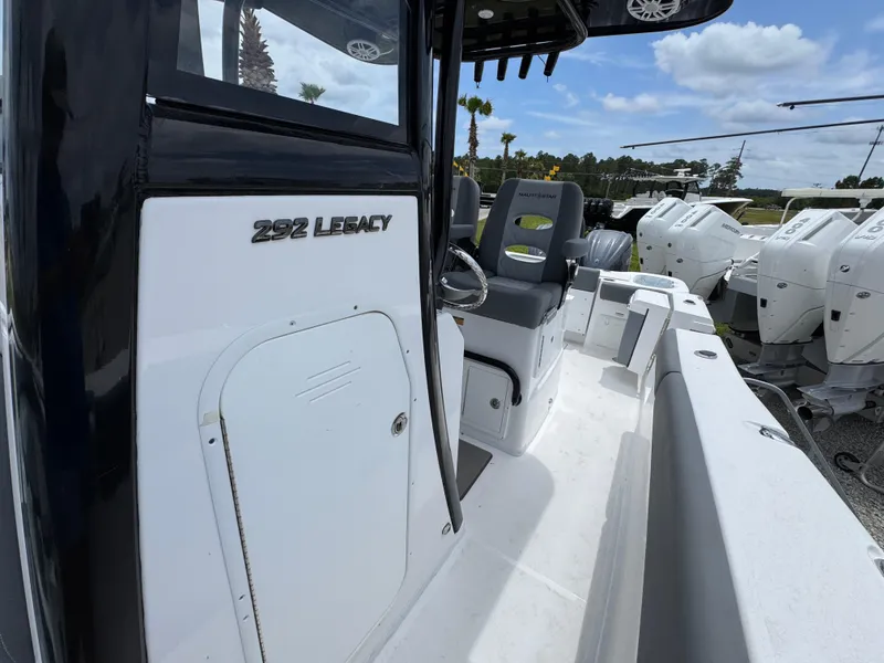 Slide: The Image of 2025 NauticStar 292 Legacy boat, sleek design, spacious seating, outdoor setting. - 15