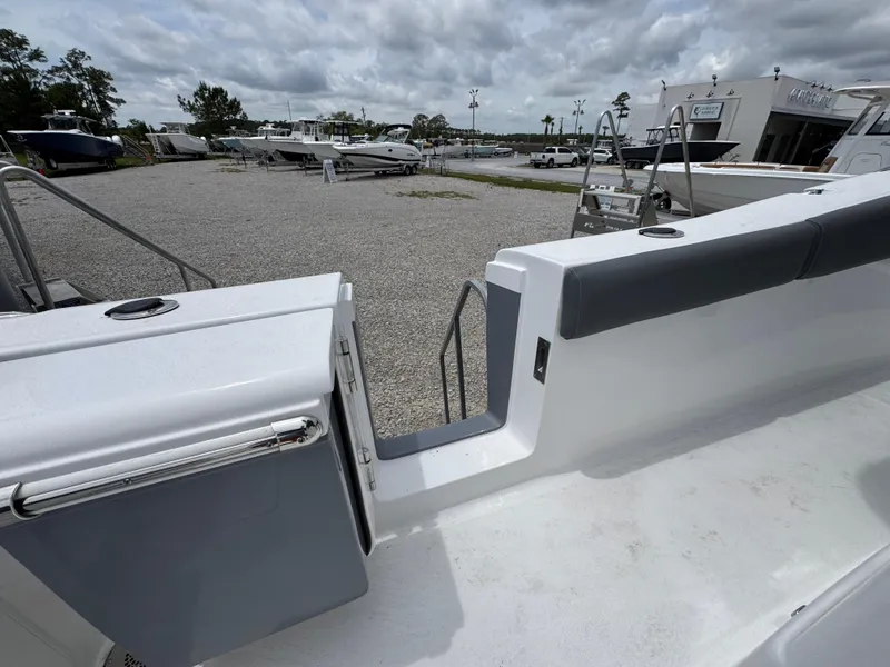 Slide: The Image of 2025 NauticStar 292 Legacy boat, featuring sleek deck design and modern amenities, in a marina setting. - 26