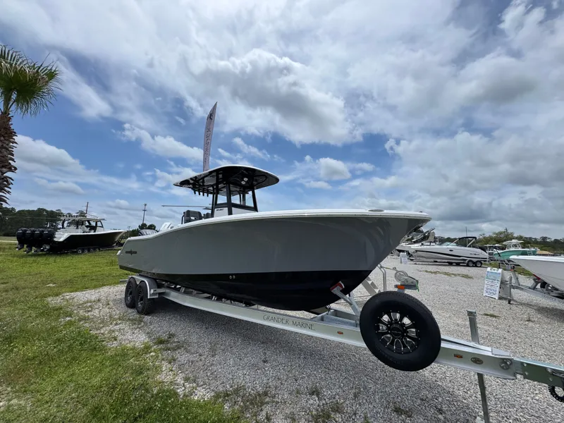 Slide: The Image of 2025 NauticStar 292 Legacy boat on trailer under cloudy sky. - 3