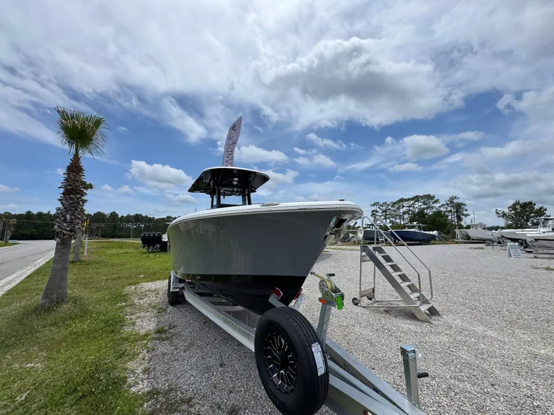 Slide: The Image of 2025 NauticStar 292 Legacy boat on trailer under cloudy sky. - 4