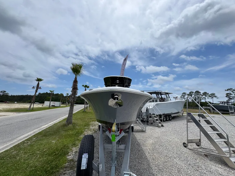 Slide: The Image of 2025 NauticStar 292 Legacy boat on trailer under cloudy sky. - 5