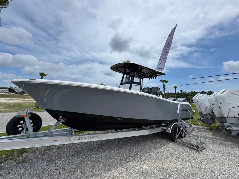 Slide: The Image of 2025 NauticStar 292 Legacy boat on trailer under cloudy sky. - 7