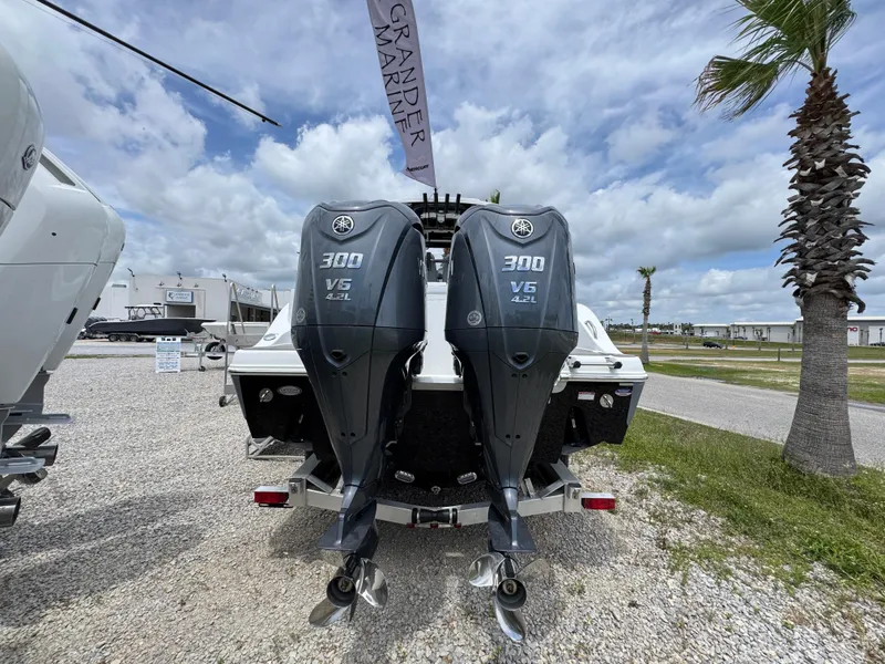 Slide: The Image of 2025 NauticStar 292 Legacy with dual 300 V6 outboard engines, displayed outdoors. - 9