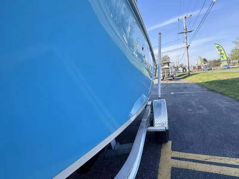 Slide: The Image of 2023 Key West 203 DFS boat on trailer, vibrant blue hull, outdoor setting. - 10