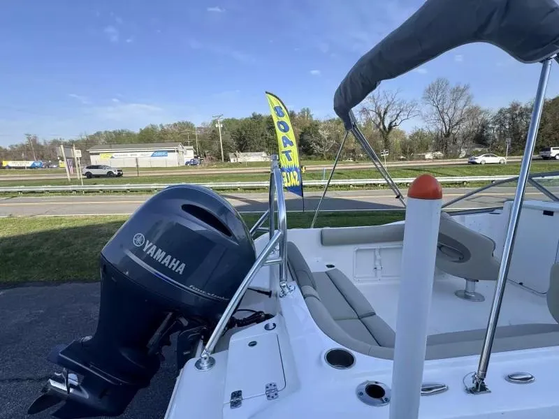 Slide: The Image of 2023 Key West 203 DFS boat with Yamaha engine, displayed outdoors near a road. - 11