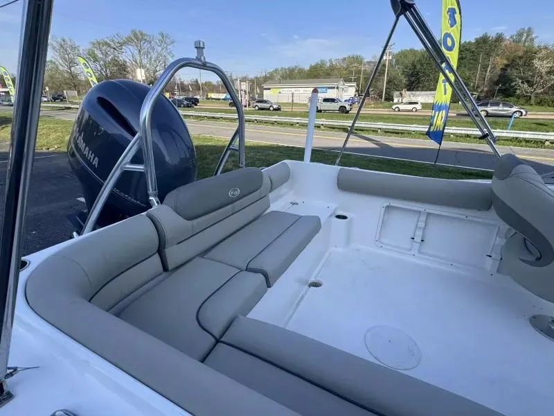 Slide: The Image of 2023 Key West 203 DFS boat interior with seating and Yamaha engine. - 12
