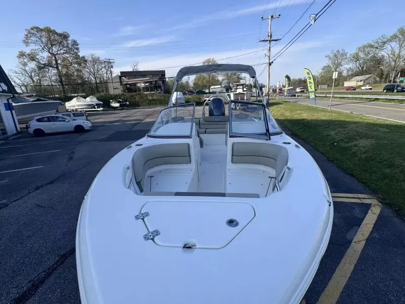 Slide: The Image of 2023 Key West 203 DFS boat with spacious seating, parked outdoors on a sunny day. - 19