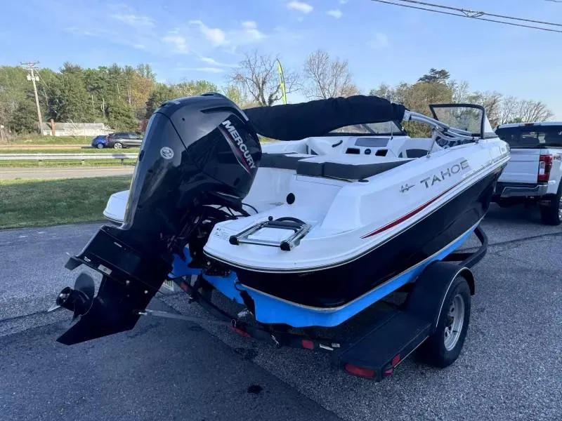 Slide: The Image of 2022 Tahoe 185 S boat with Mercury outboard motor on trailer, parked outdoors. - 5