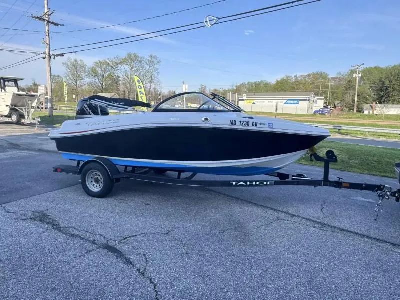 Slide: The Image of 2022 Tahoe 185 S boat on trailer, parked outdoors on a sunny day. - 6