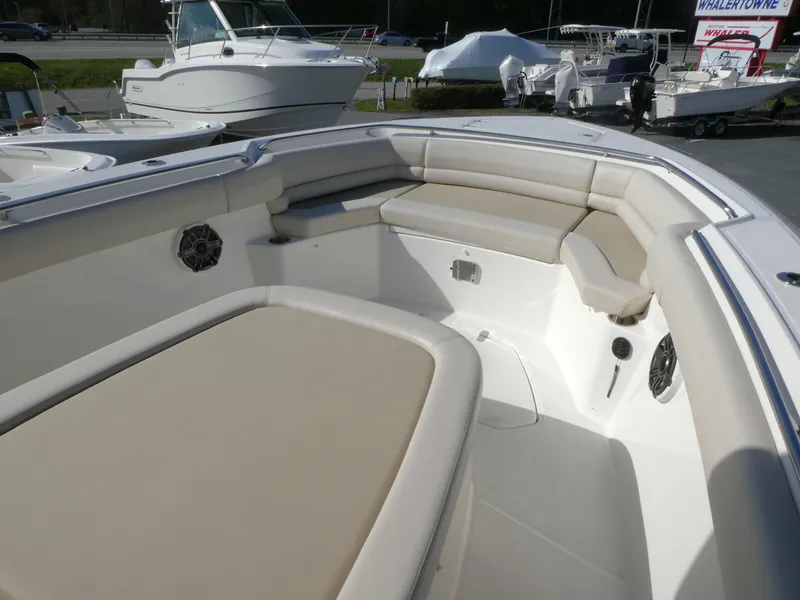 Slide: The Image of 2025 Boston Whaler 330 Outrage boat interior with beige seating and modern design. - 14