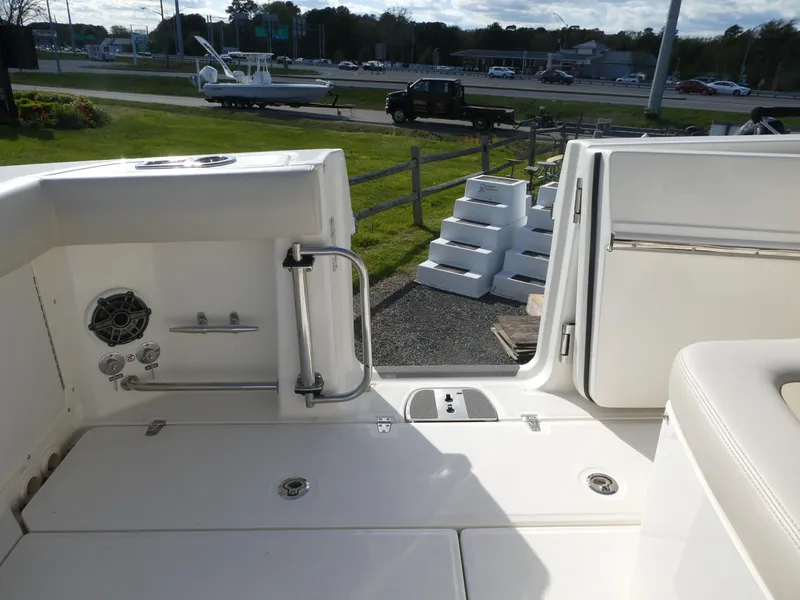 Slide: The Image of 2025 Boston Whaler 330 Outrage boat deck with seating and storage compartments. - 16
