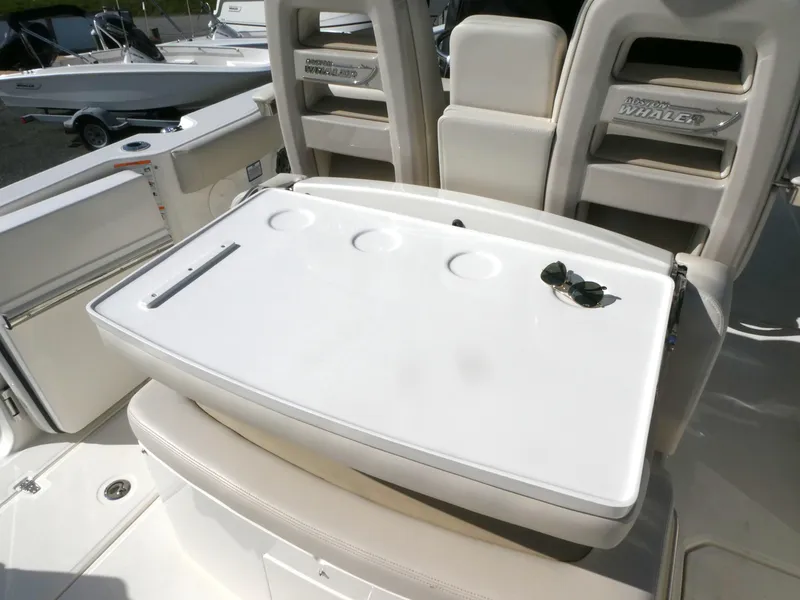 Slide: The Image of 2025 Boston Whaler 330 Outrage boat interior with seating and table. - 7