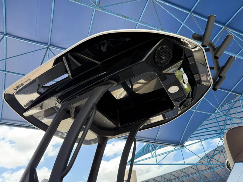 Slide: The Image of 2025 Yamaha Boats 222 FSH Sport E, sleek black design under blue canopy. - 15